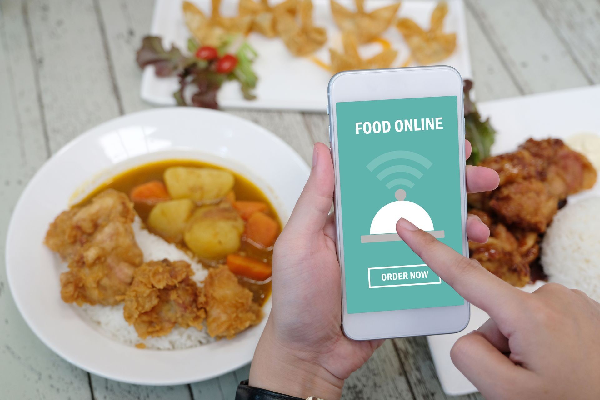Hand holding smart phone with food online device on screen over blur cafe background, with copy space for text, mock up, template, food online, food delivery concept